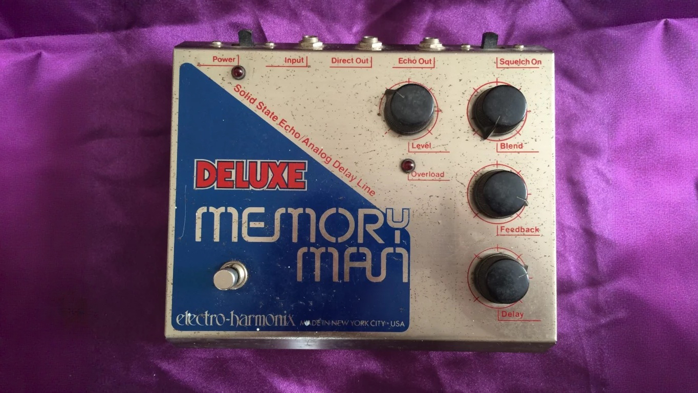 Late-1970s Electro-Harmonix Deluxe Memory Man with the logo printed on a dark blue triangle and no modulation controls.