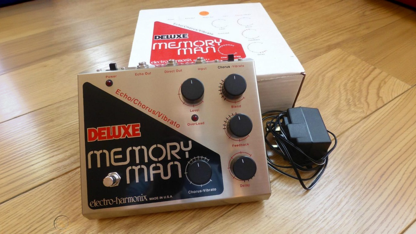 1990s reissue Electro-Harmonix Deluxe Memory Man with external power supply, shown next to its box.